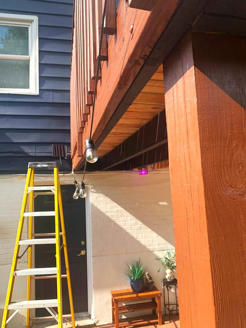 Freshly stained deck post and joists under an elevated deck