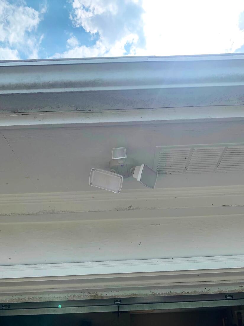 New motion-sensor floodlight mounted under the eaves